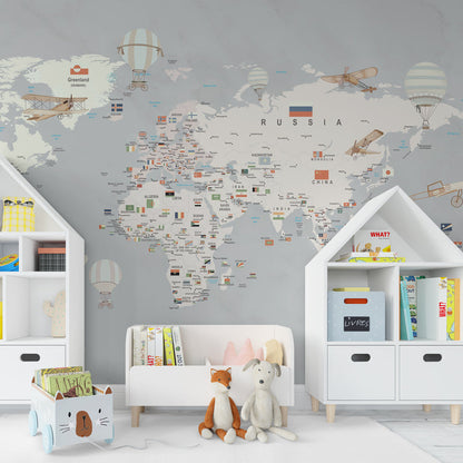 Kids-Mundo grey-tone world map wall mural in a playroom, a calm backdrop for imaginative travel play.