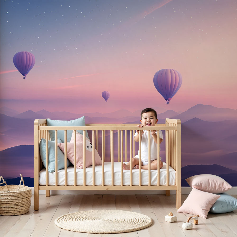 Hot air balloon mural wallpaper in dreamy pastel nursery with white crib by Kids-Mundo