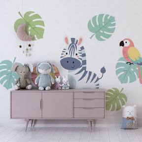 Lion and zebra wallpaper with monstera leaves transforming kids playroom into jungle safari