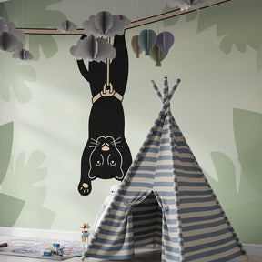 Rope-swinging panther mural wallpaper transforming kids' playroom into jungle adventure space