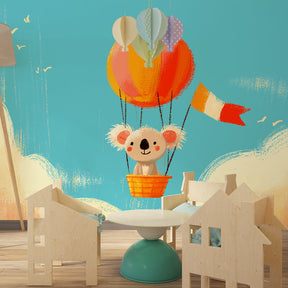 Blue sky koala balloon wallpaper creating dreamy toddler bedroom atmosphere