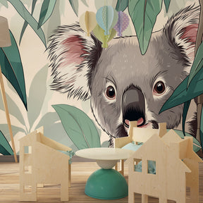 Lush koala wallpaper transforming kids bedroom into nature sanctuary with green botanical elements