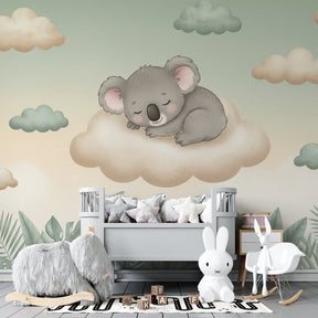 Sleeping koala on cloud wallpaper creating serene atmosphere in baby bedroom with soft lighting