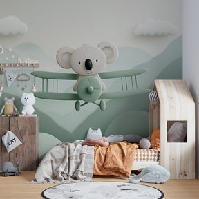 Mountain landscape wallpaper with koala airplane creating peaceful children's bedroom decor