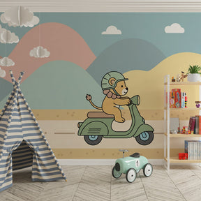 Adventure-themed kids bedroom featuring lion on scooter mural wallpaper with soft pink and blue hills
