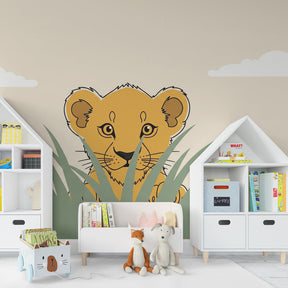 Curious lion cub wallpaper creating adventure themed kids bedroom with wooden furniture