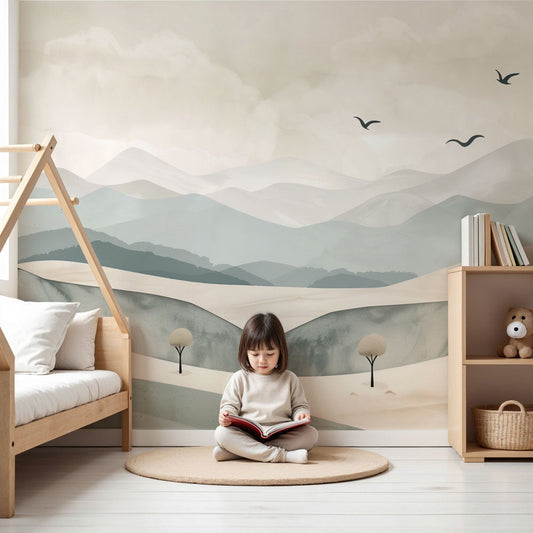 Kids-Mundo misty mountain wall mural styled in a calm neutral nursery with a cot and soft furnishings.