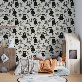 Monkey and foliage mural wallpaper showcased in elegant nursery with natural wood furniture