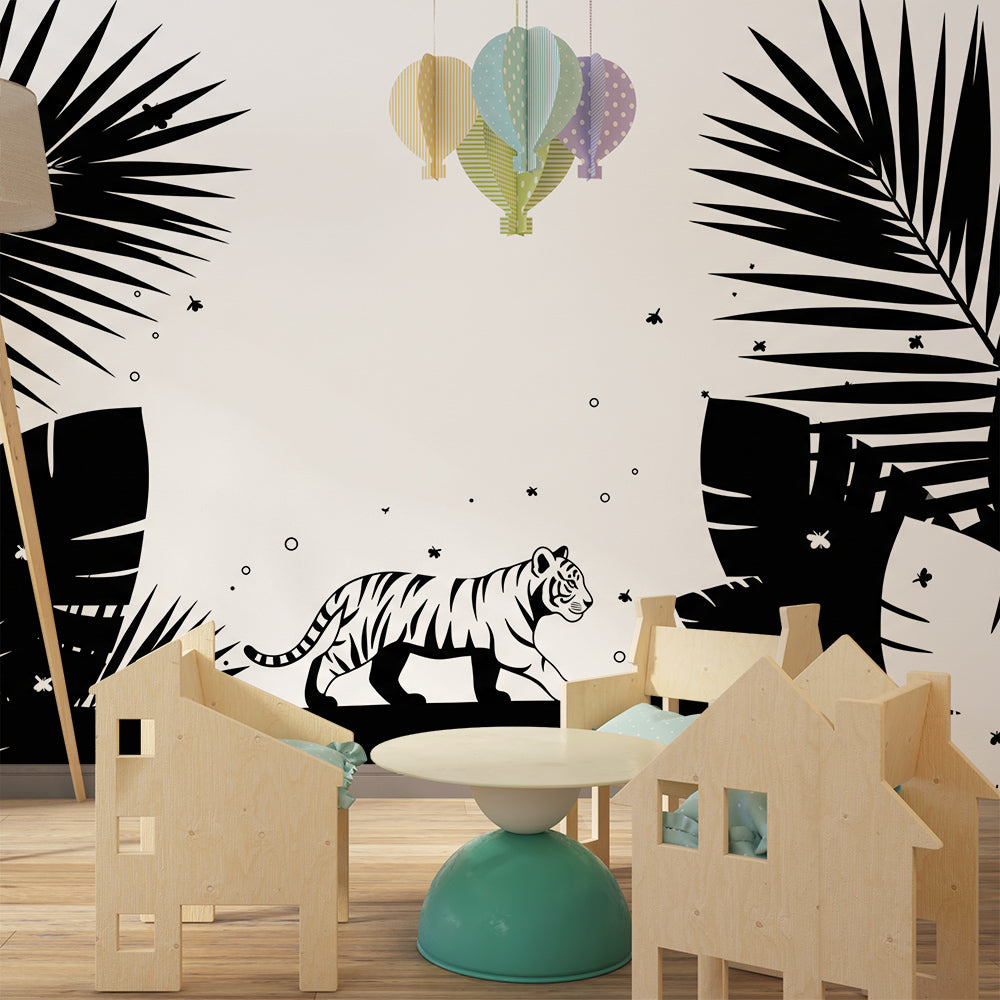 Kids-Mundo monochrome jungle wall mural styled behind a reading chair and books in a playroom.