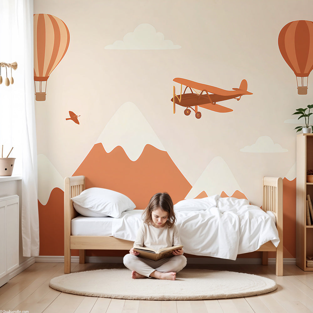 Mountain adventure mural wallpaper with airplane and hot air balloons in modern nursery by Kids-Mundo