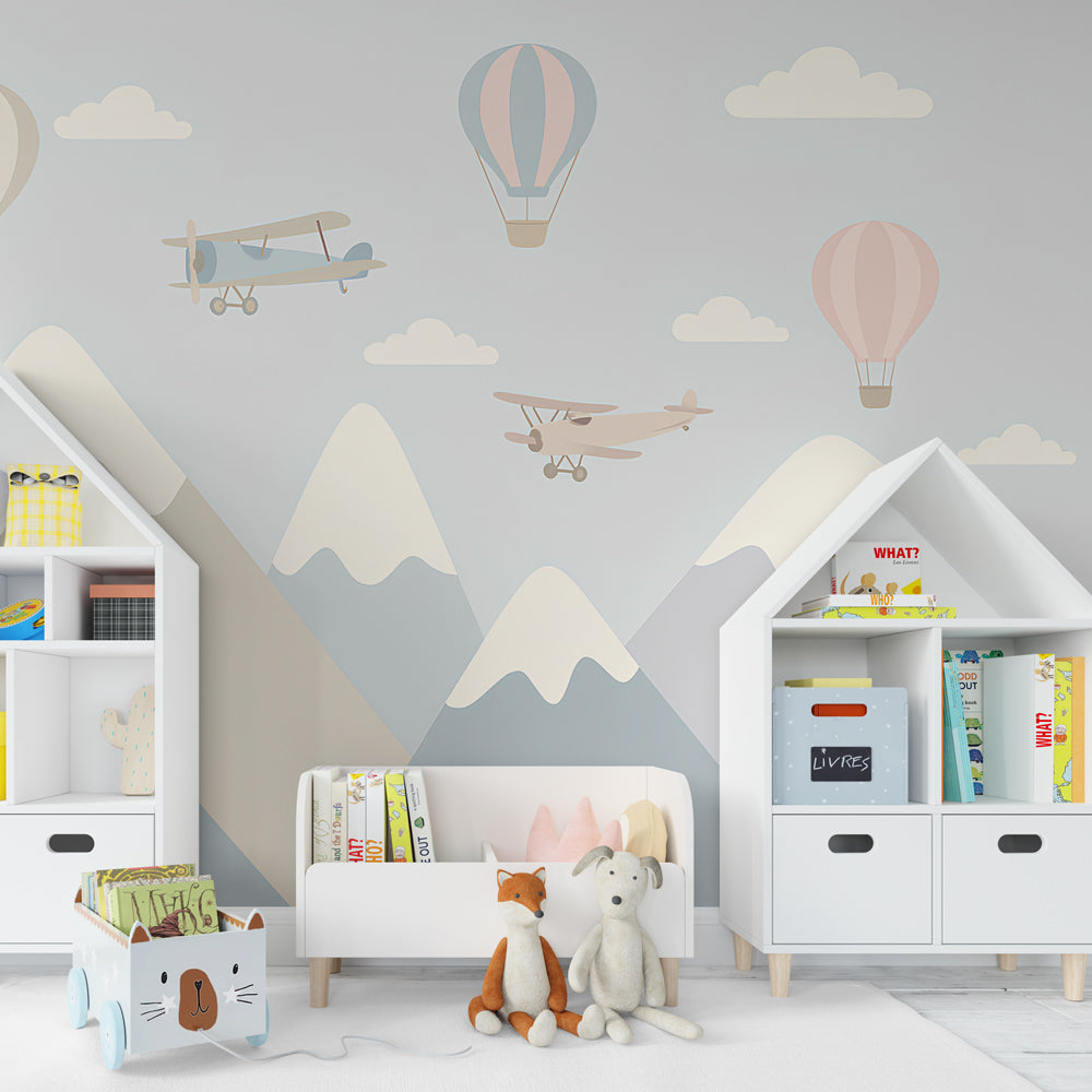 Adventure themed mural wallpaper featuring mountains and flying elements in children's playroom