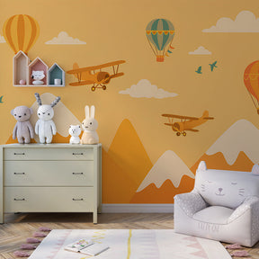 Adventure-themed mural wallpaper with balloons and mountains in children's playroom