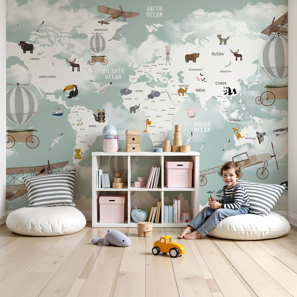 Kids-Mundo mountain world map wall mural in a nursery, pandas and toucans among snowy peaks above the cot.