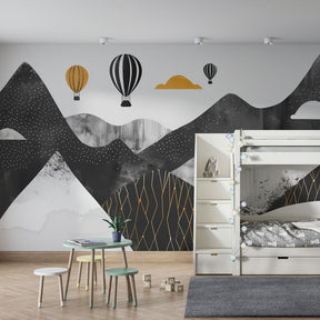 Hot air balloon wallpaper with black mountains transforming child's bedroom into dreamy landscape
