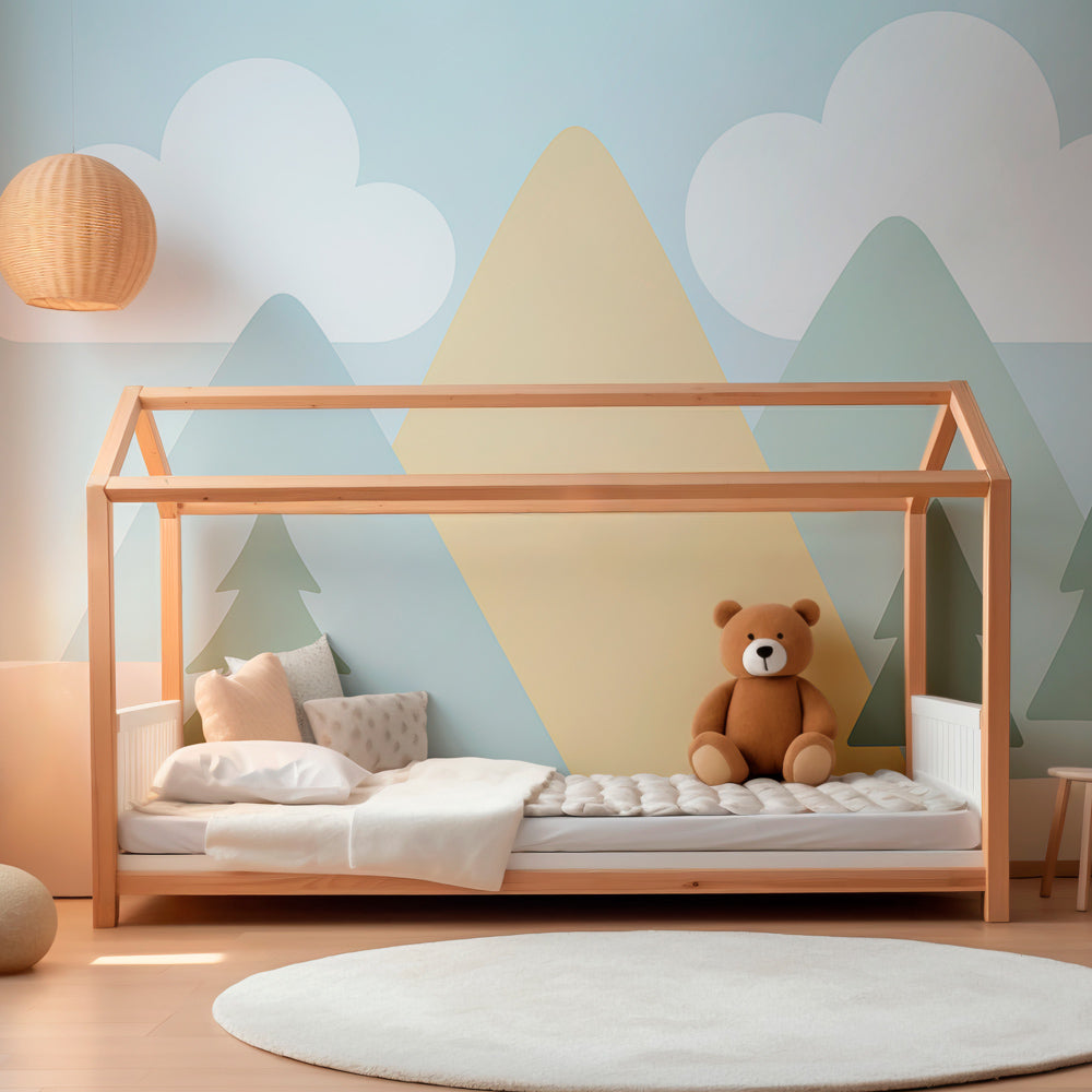 Mountain landscape wallpaper in bright children's playroom with wooden toys and soft furnishings