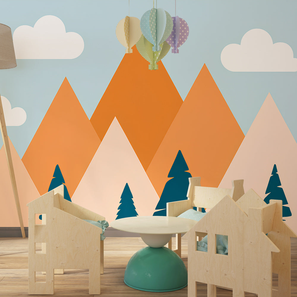 Adventure-themed mountain wallpaper in children's playroom with colorful peaks and blue trees