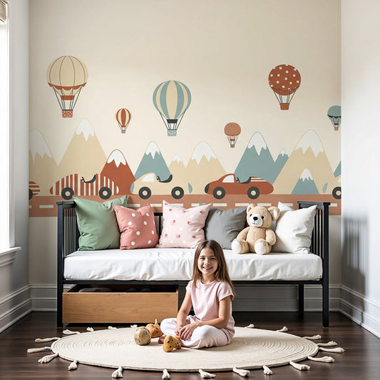 Kids-Mundo mountain road trip wall mural with balloons in a cream baby nursery room