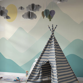 Gentle mountain landscape wallpaper transforming children's bedroom with calming blue and green tones