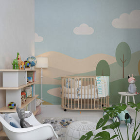 Gentle hills and stream mural wallpaper creating calming atmosphere in kids bedroom