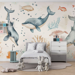 Blue whale and dolphin wallpaper creating underwater theme in baby nursery room