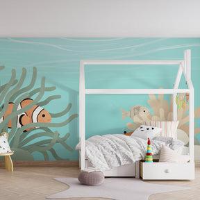 Underwater theme nursery featuring colorful marine life wallpaper with clownfish and coral