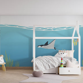 Marine life mural wallpaper featuring manta ray and fish in bright kids playroom by Kids-Mundo