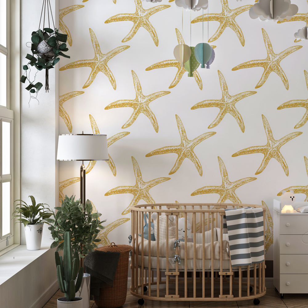Ocean starfish wallpaper creating serene children's bedroom with white and gold theme