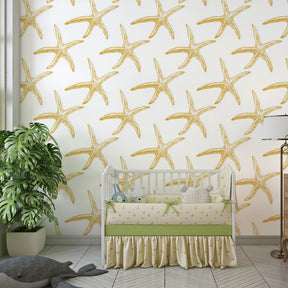 Maritime starfish wallpaper in kids playroom with ocean-themed furniture and toys