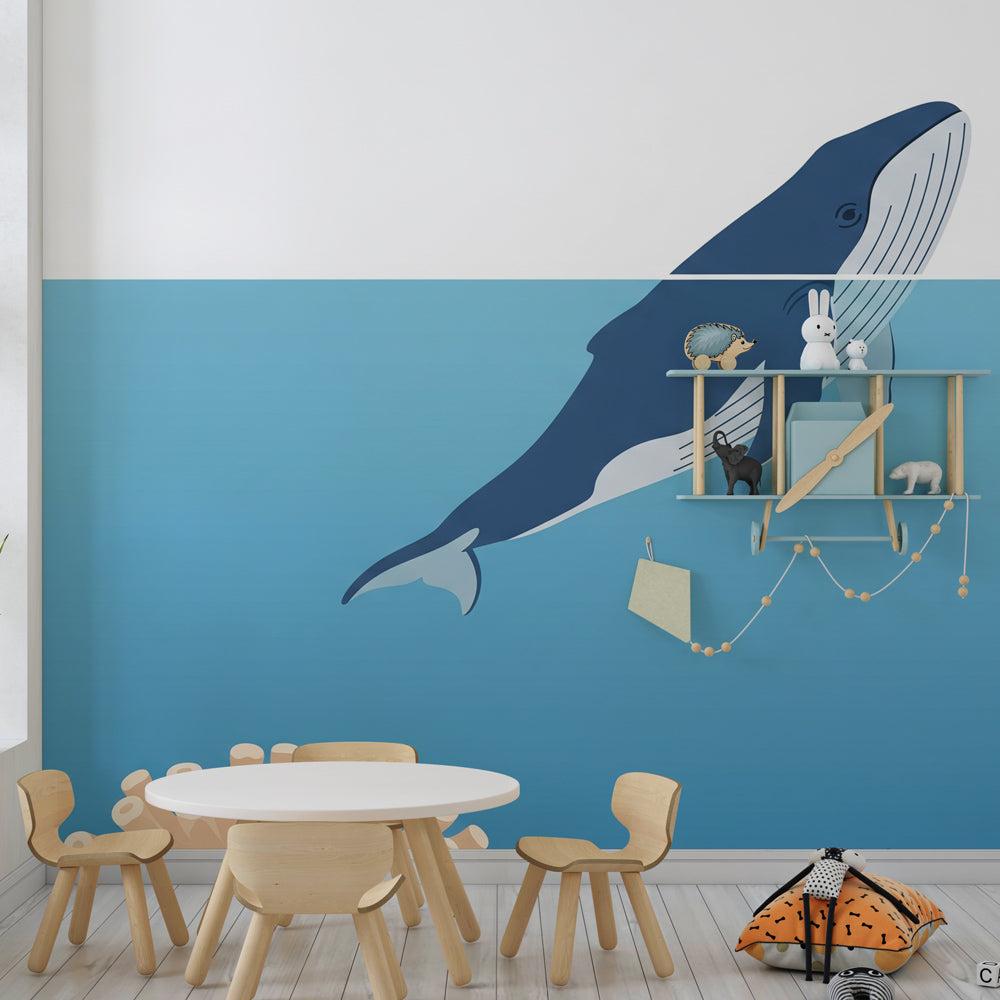 Underwater whale wallpaper creating calming blue atmosphere in children's bedroom