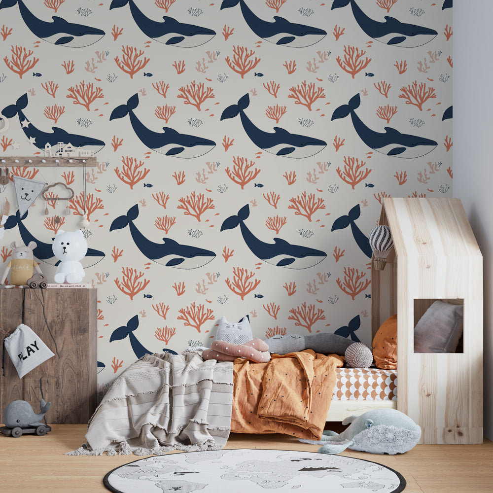 Marine life wallpaper featuring whales and coral formations in bright kids playroom setting
