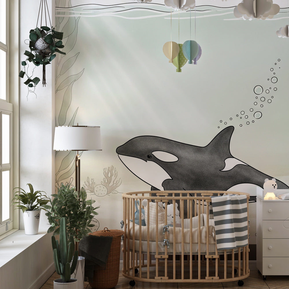 Underwater orca wallpaper with natural wood furniture in coastal kids room by Kids-Mundo