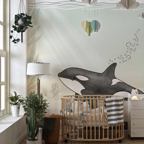 Underwater orca wallpaper with natural wood furniture in coastal kids room by Kids-Mundo