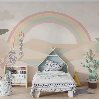 Kids-Mundo desert rainbow mural styled behind a bed in a soft kids bedroom