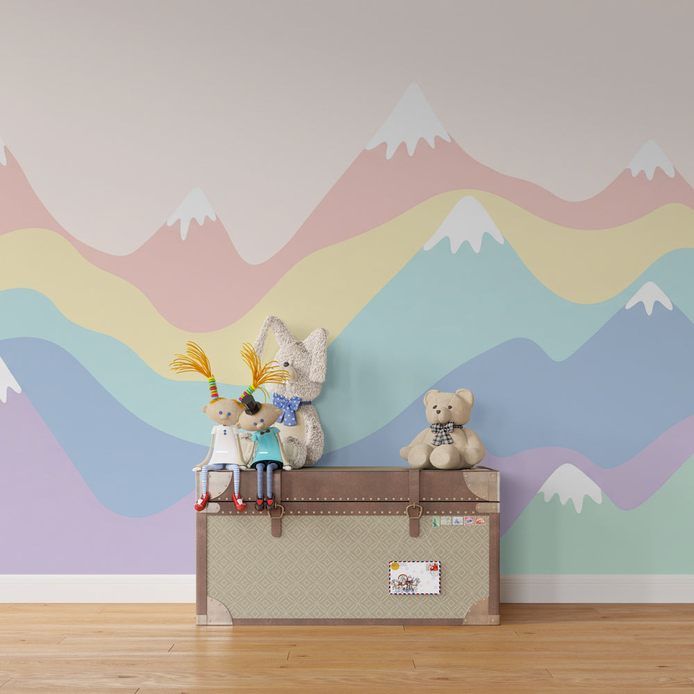 Kids-Mundo rainbow mountain wall mural behind a bed in a bright kids bedroom.