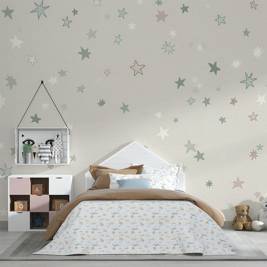 Kids-Mundo pastel stars wall mural on a feature wall above a cot in a soft kids bedroom
