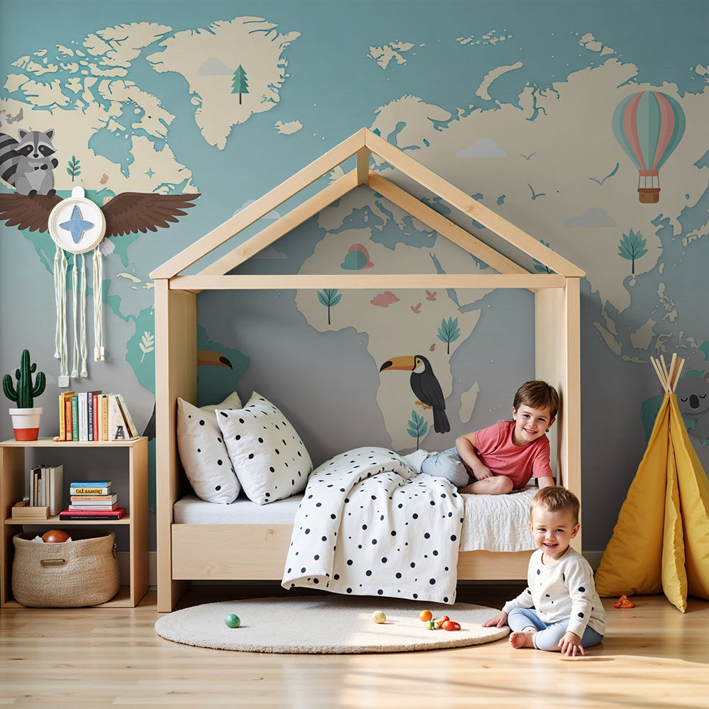 Pastel world map wall mural with toucan and hot air balloon painted in a Kids-Mundo nursery