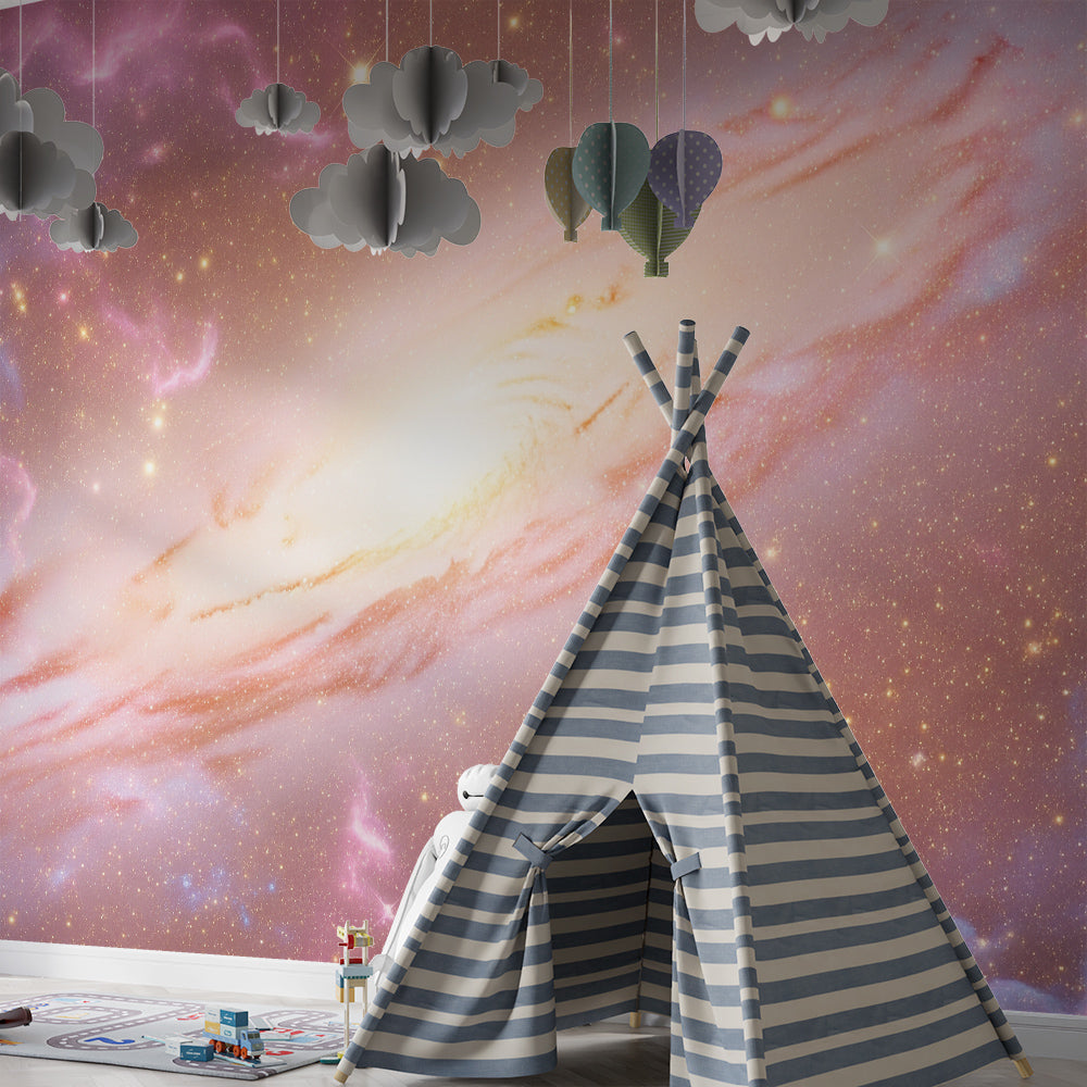 Kids-Mundo pink and gold galaxy mural brightening a playroom wall with toy shelves.