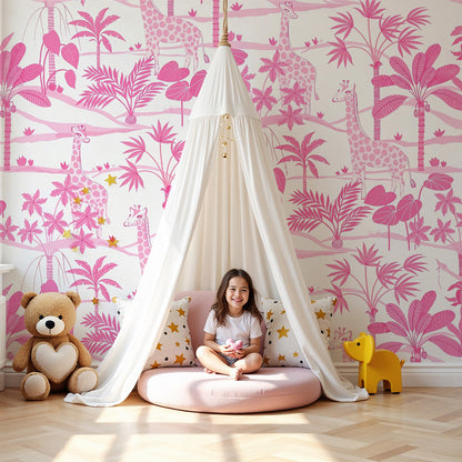 Kids-Mundo pink giraffe jungle wall mural in a bright nursery with a cot and soft furnishings