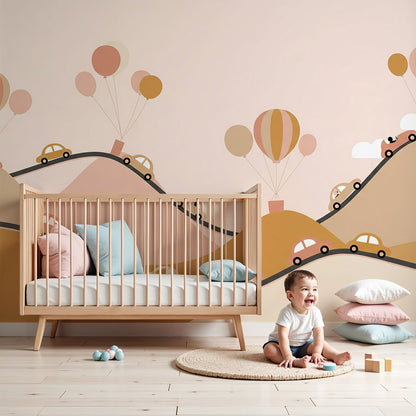 Kids-Mundo pink mountain road wall mural with cars and balloons in a soft baby nursery room