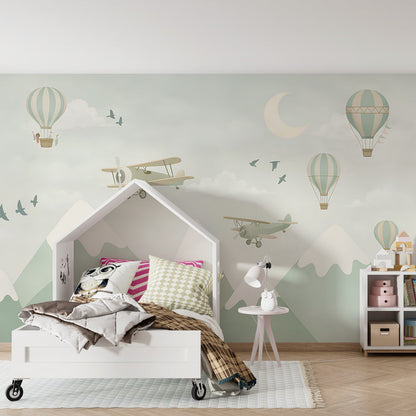 Kids-Mundo mountain sky wall mural with balloons and planes shown in a kids' bedroom