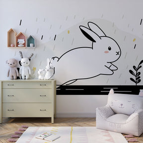 Playful bunny rain wallpaper creating whimsical toddler bedroom decor atmosphere