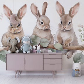 Baby animal mural wallpaper with three rabbits on branch in cozy toddler bedroom