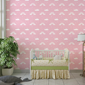 Cloud and rainbow mural wallpaper creating cozy playroom atmosphere for children