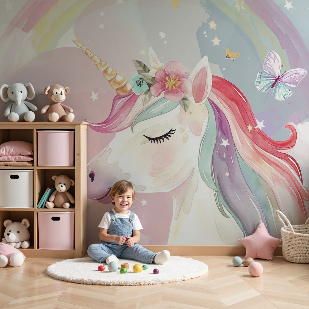 Kids-Mundo rainbow unicorn wall mural styled above a cot in a soft pink nursery.