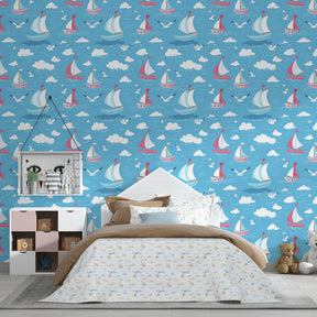 Maritime themed children's bedroom featuring sailboat mural wallpaper with red and pink sails by Kids-Mundo