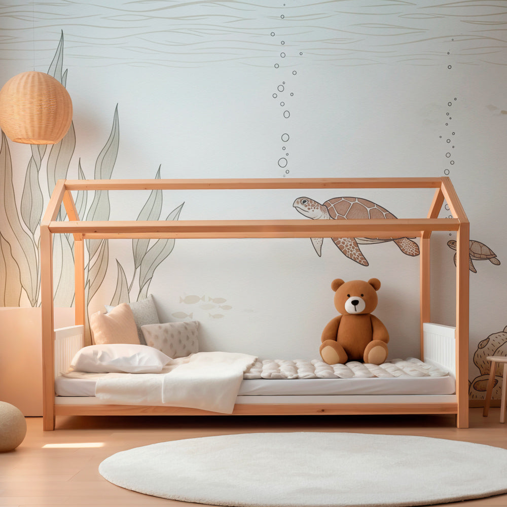 Ocean themed nursery featuring sea turtle wallpaper creating calming underwater atmosphere