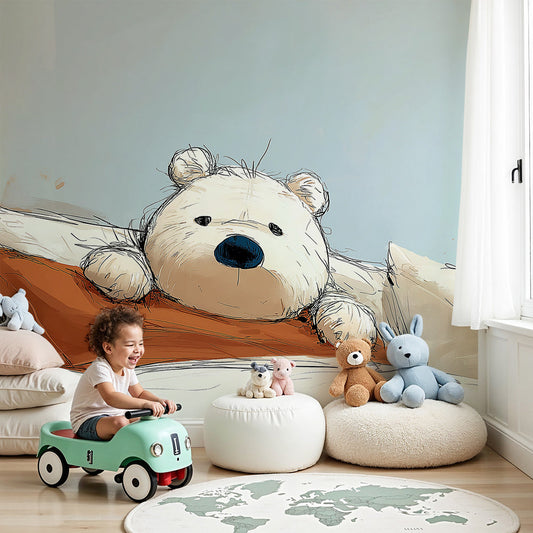 Kids-Mundo teddy bear wall mural in a soft blue nursery beside a cot and cream curtains