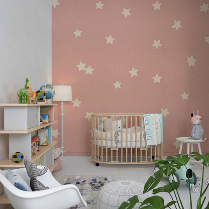Kids-Mundo scattered star wall mural brightening a playroom wall behind a toy shelf and reading nook.
