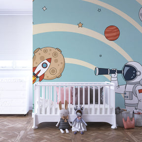 Space-themed mural wallpaper transforming kids playroom into intergalactic adventure zone