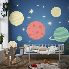 Starry universe wallpaper creating magical nursery atmosphere with planets and stars on blue background